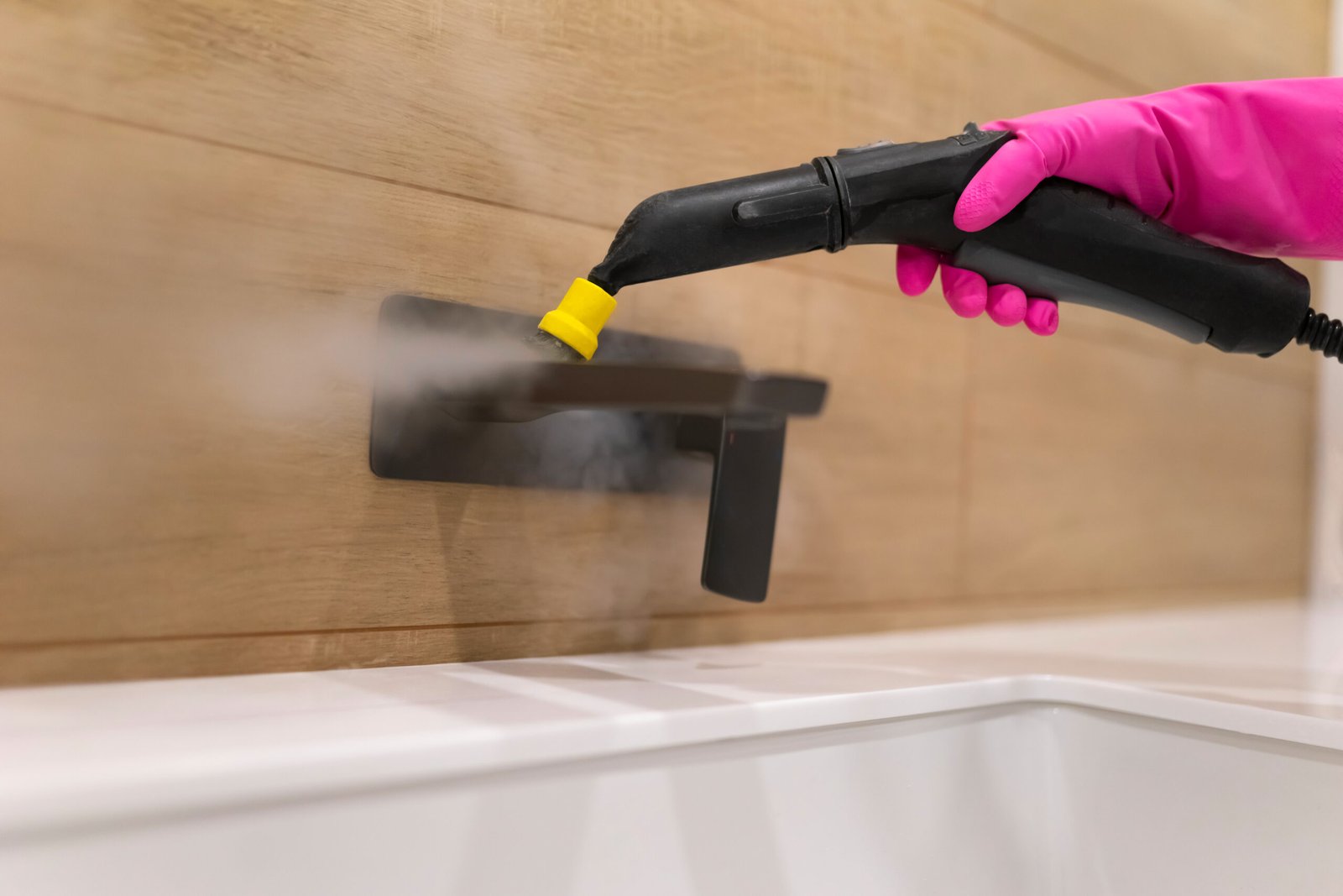 Cleaning the faucet from fungi and dirt with steam cleaner. Bathroom cleaning process